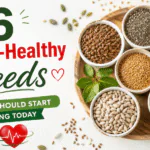 6 Heart-Healthy Seeds You Should Start Eating Today A variety of heart-healthy seeds including flaxseeds, chia seeds, pumpkin seeds, sesame seeds, sunflower seeds, and hemp seeds arranged around a heart symbol to promote cardiovascular health.